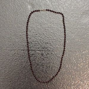 Amethyst colored necklace with gold color beads